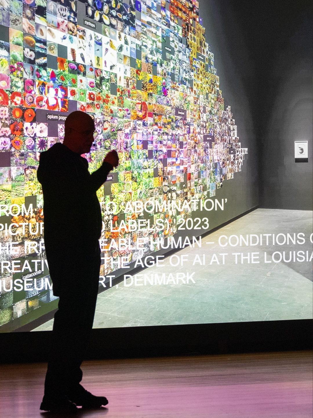 Trevor Paglen speaking at the Guggenheim Museum public program with his work “From ‘Apple’ to ‘Abomination’” in the background