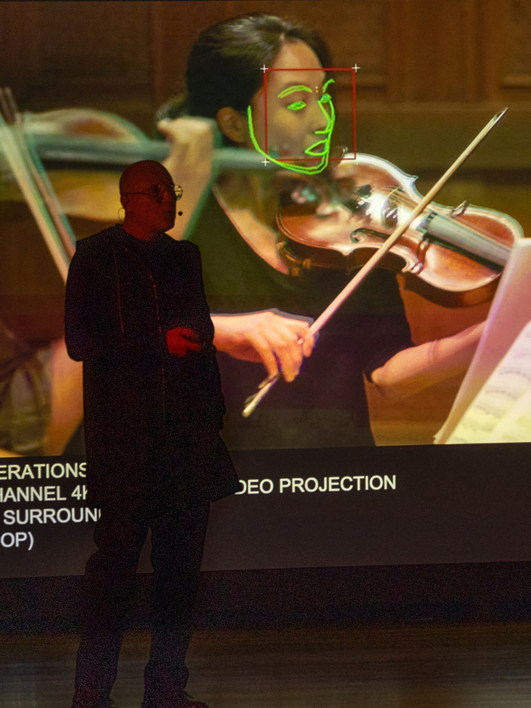 Trevor Paglen speaking at the Guggenheim Museum public program with his work “Image Operations” in the background