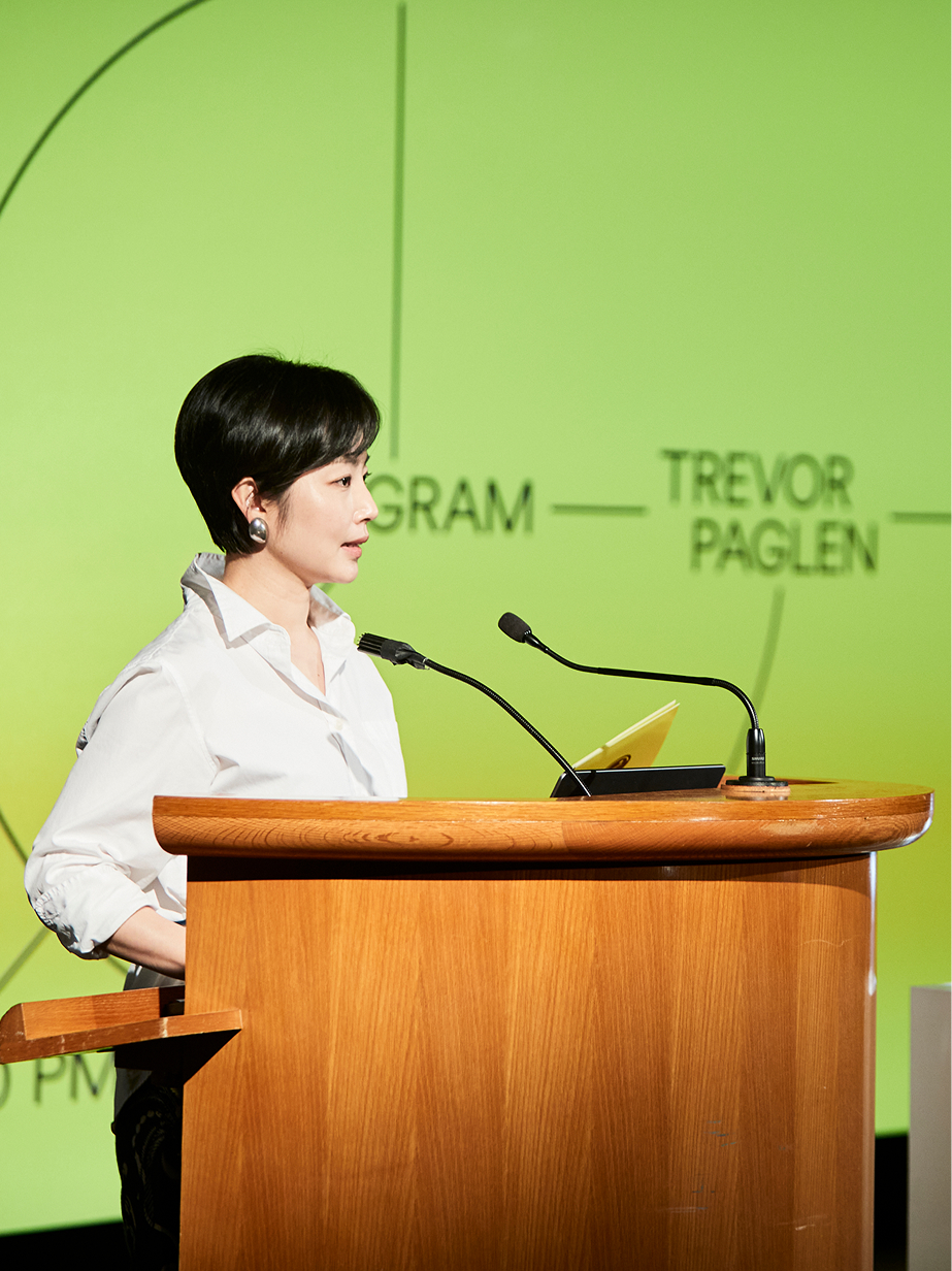 LG representative delivering welcome remarks with the LG Guggenheim Art and Technology Initiative visual identity in the background