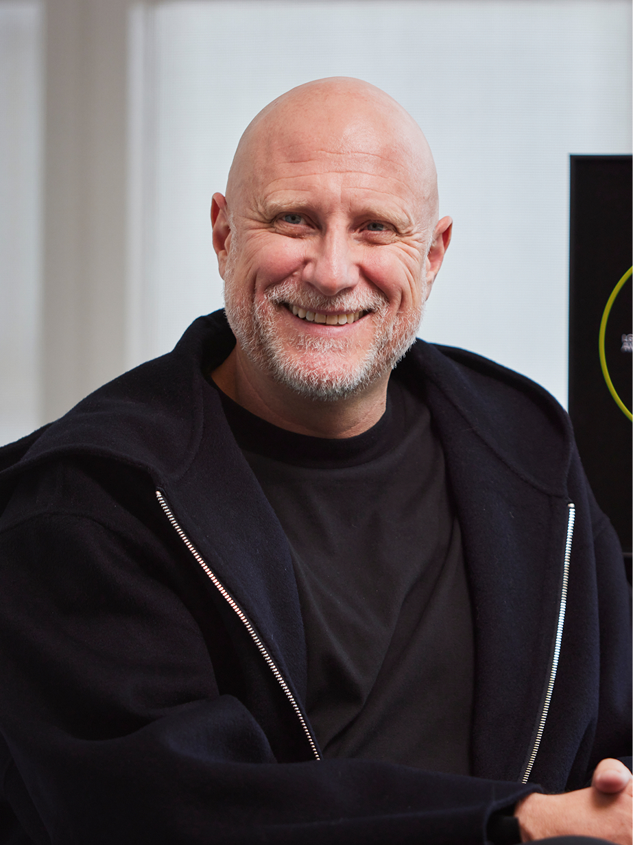 Trevor Paglen filming a media interview with the LG Guggenheim Award trophy in the background
